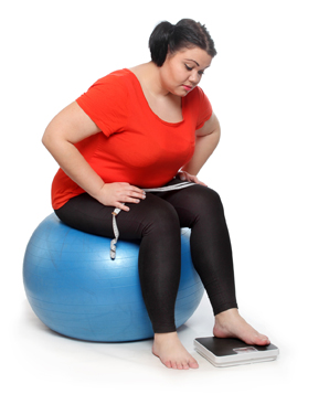 Overweight woman with a weighing machine and measure tape.