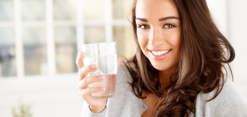 attractive young woman drinking coffee at home
